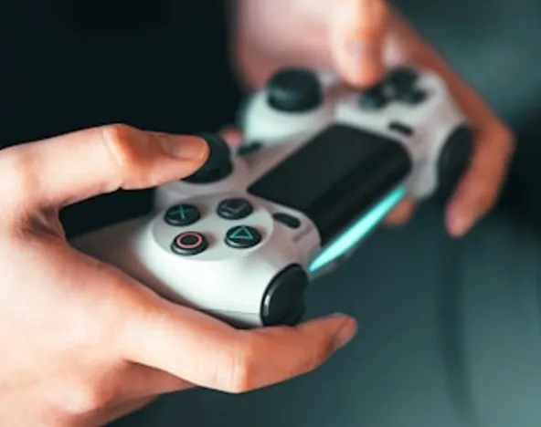 Hands holding a video game controller.